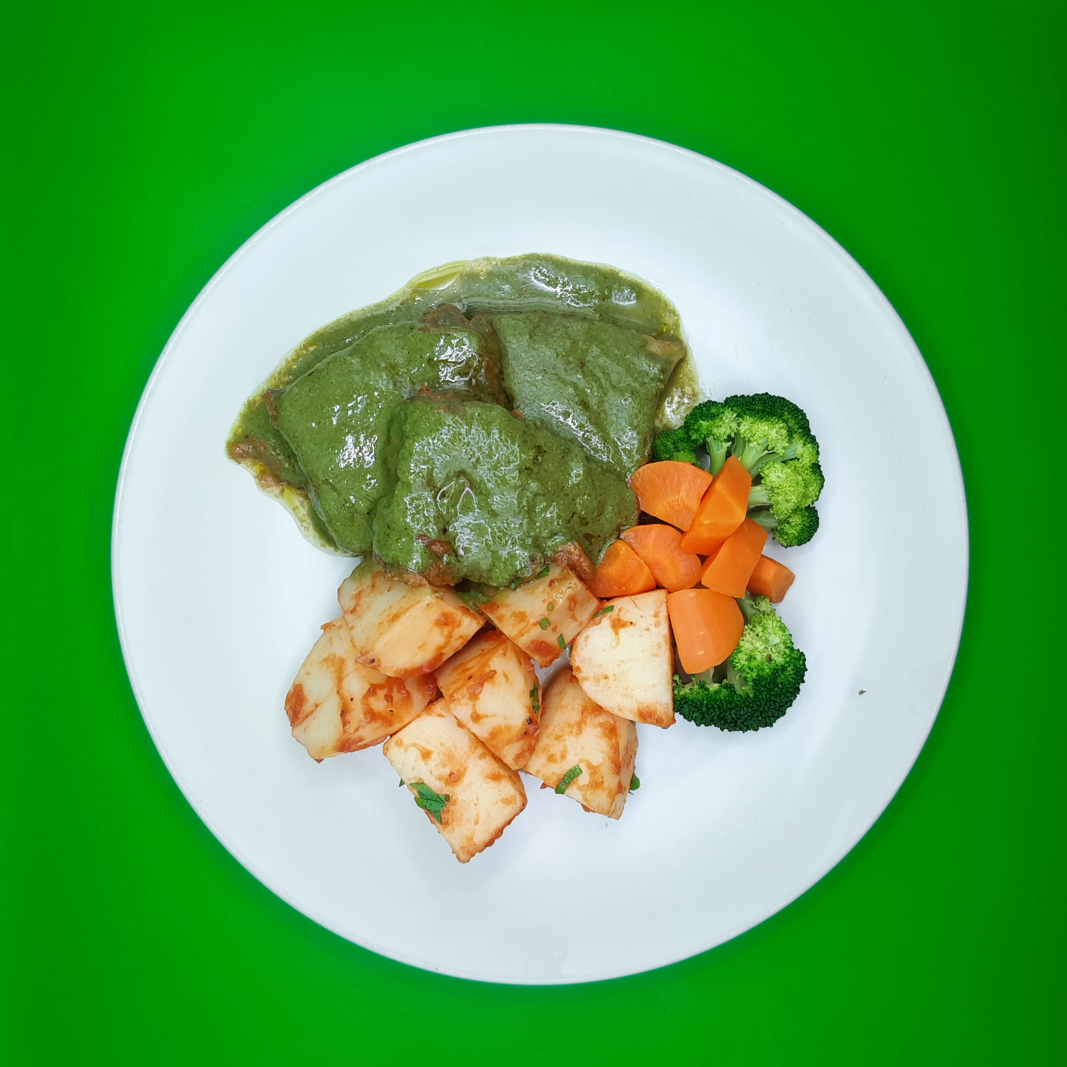 Saucy green fish with roasted potato